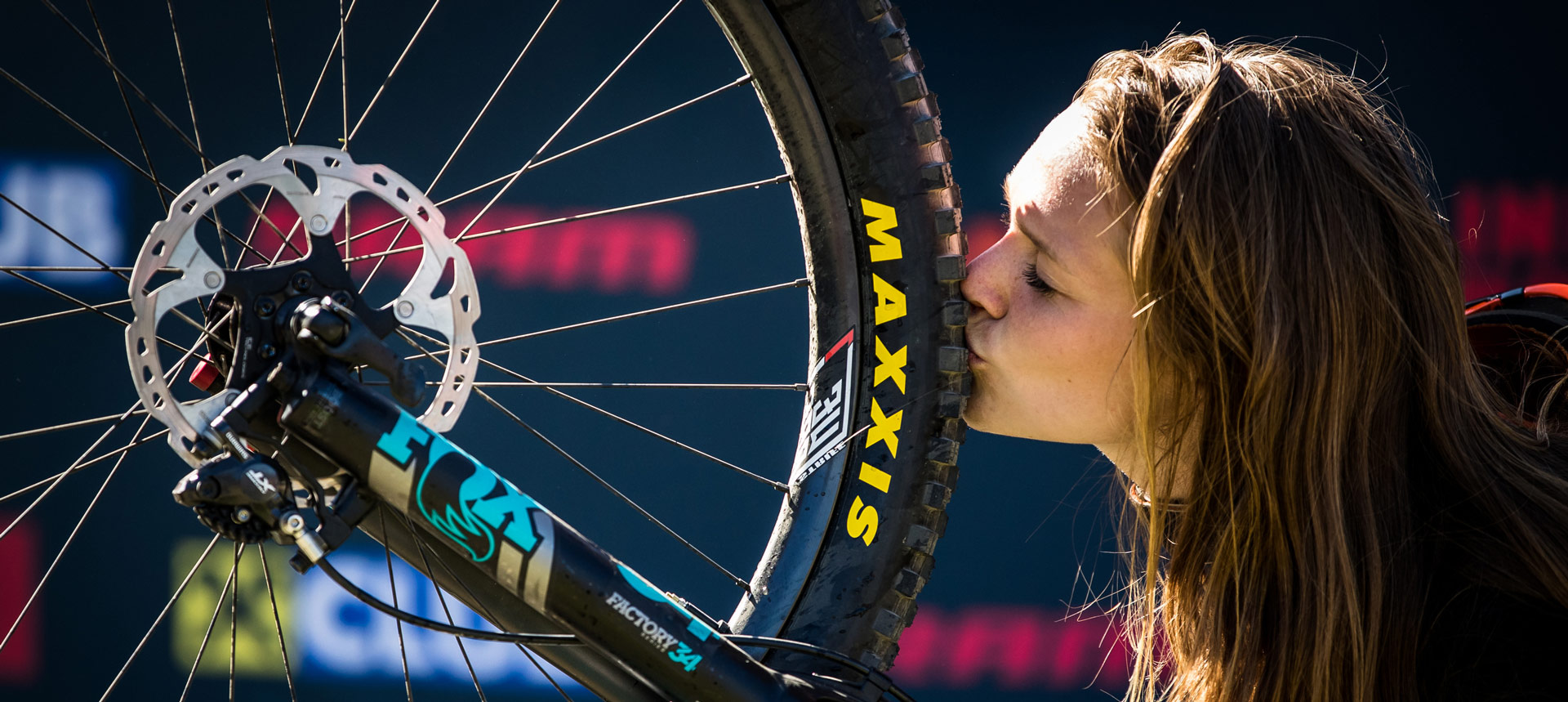 Rider celebrates Crankworx win by kissing her tire.
