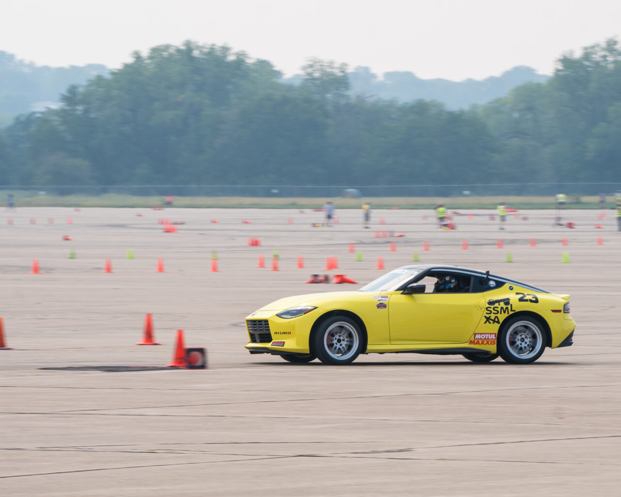 Yellow Nissan sedan racing