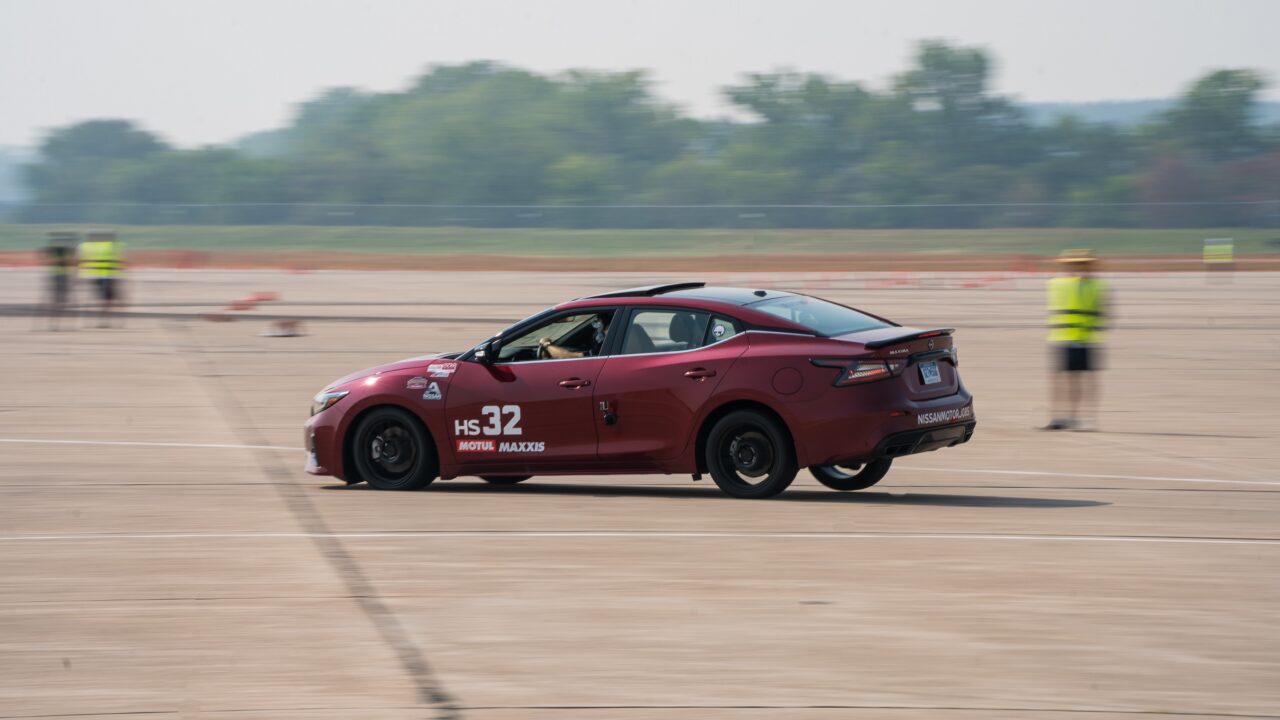 Red Nissan sedan racing