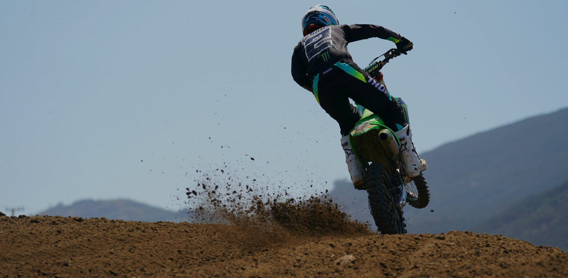 Motorcycle racer kicking up dirt.