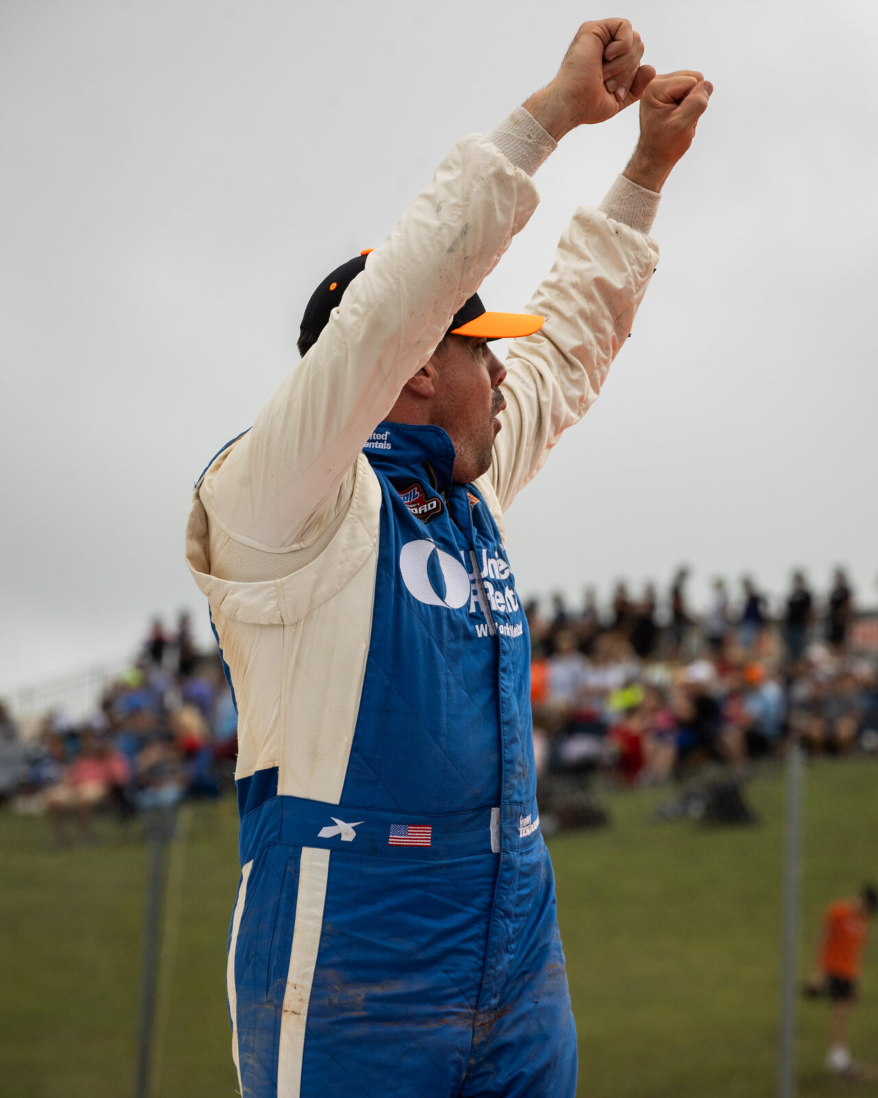 Jimmy Henderson celebrating a win with his arms hoisted high in the air