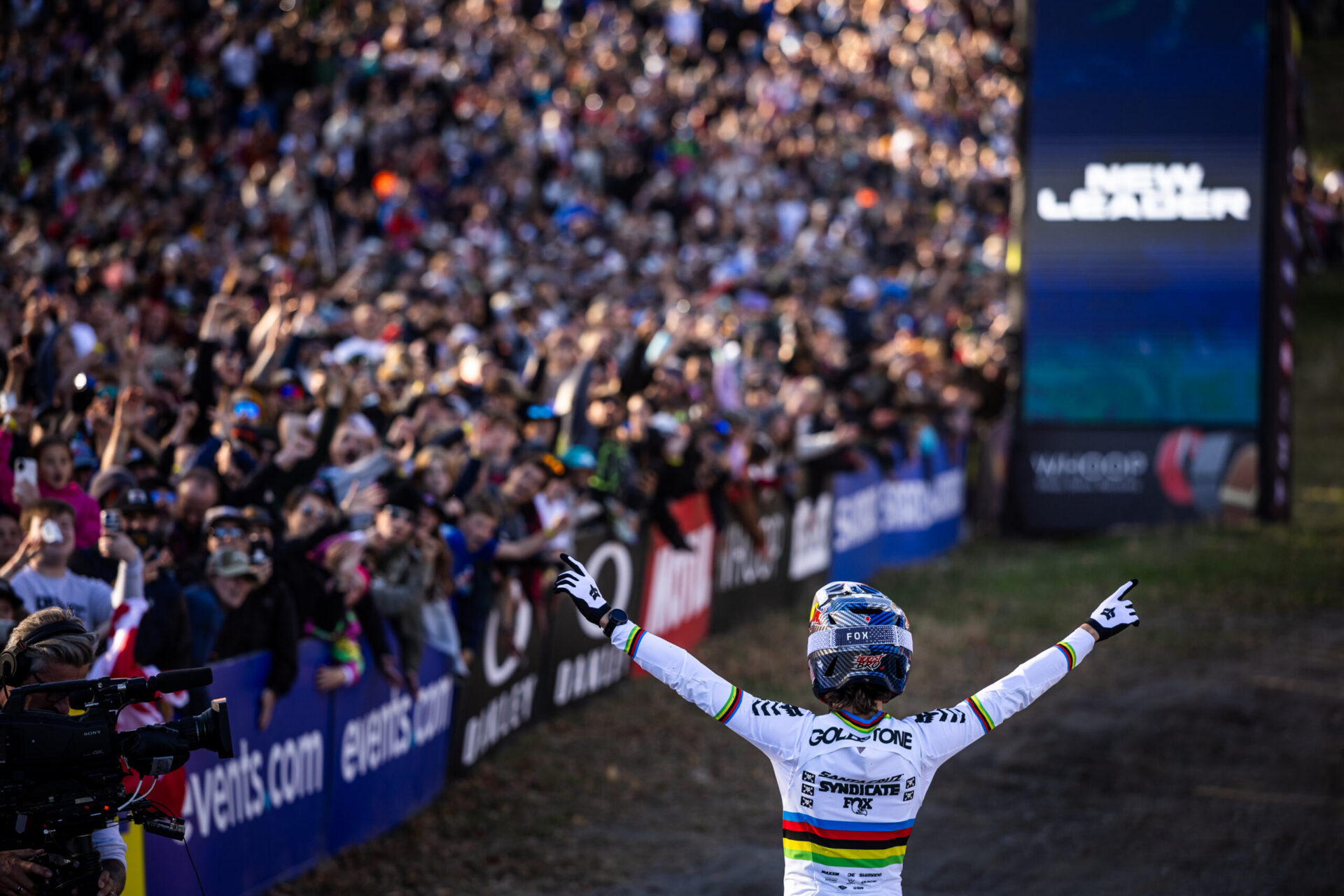 World Cup downhill rider celebrates in front of a packed crowd after a race run on Maxxis gravity tires.