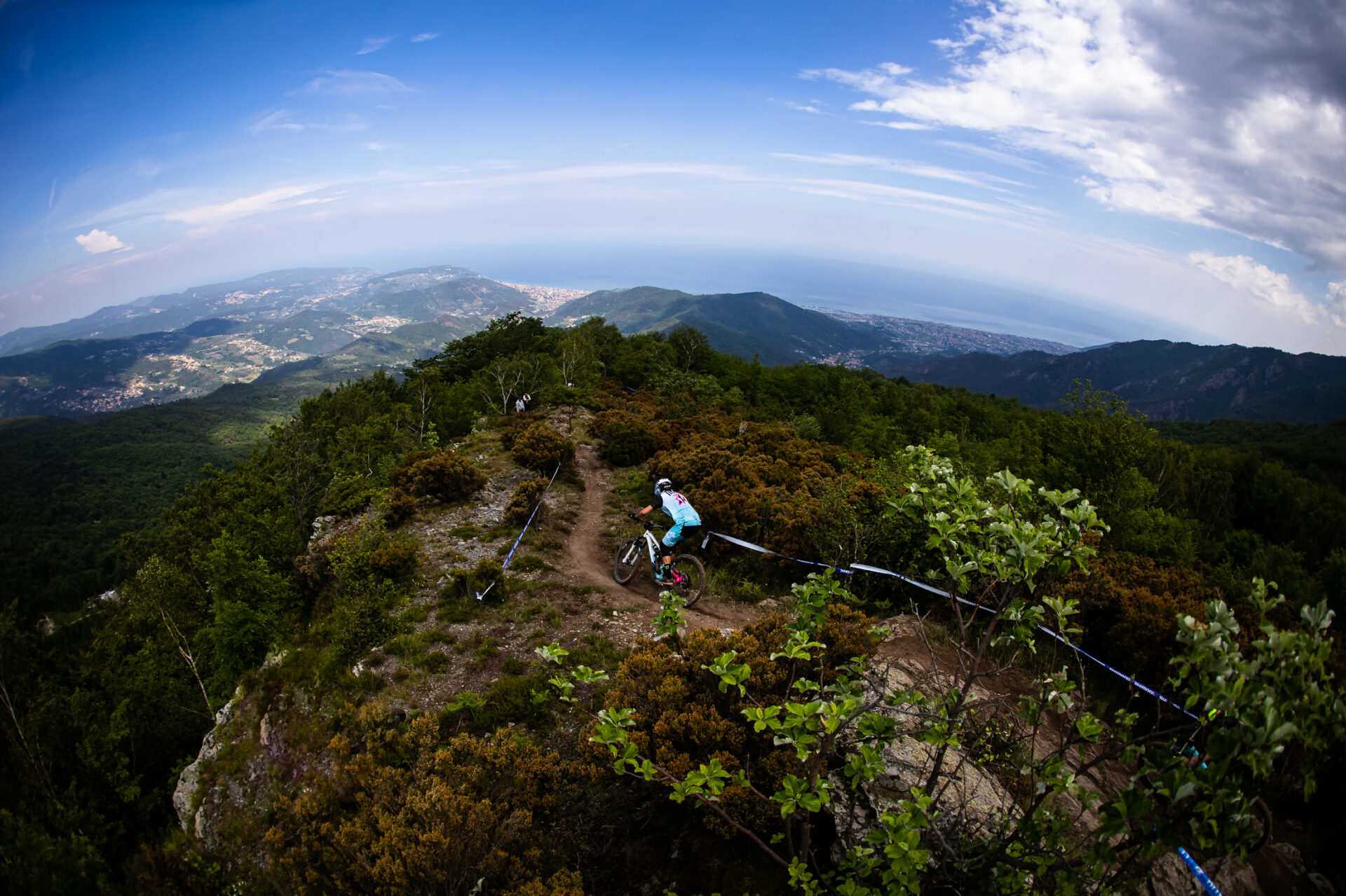 Rider cruising down Italy trails with a view