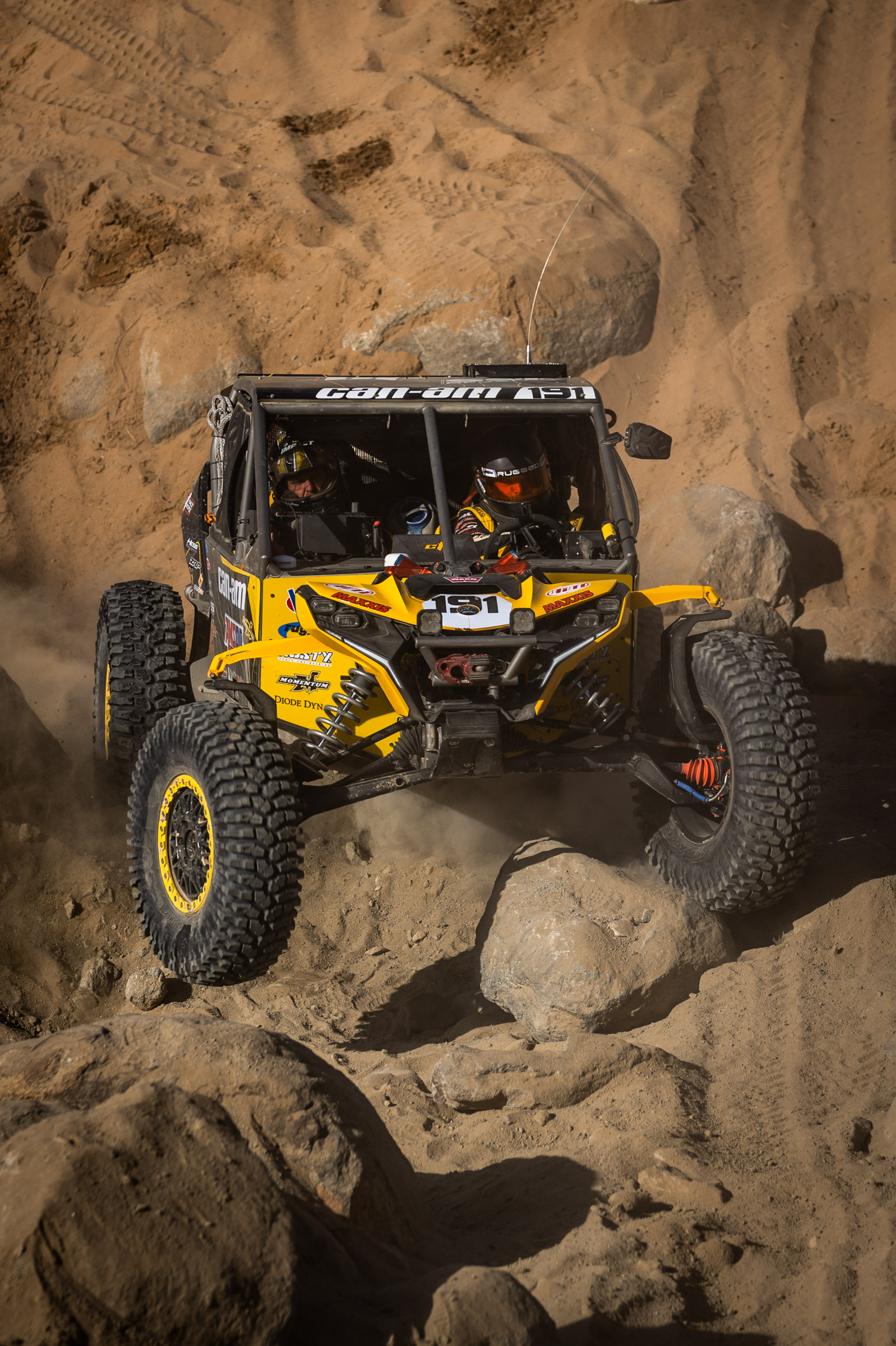 Kyle chaney in his black and yellow CanAm SxS navigating a rock section in the 4400 Class race of KOH 2025.