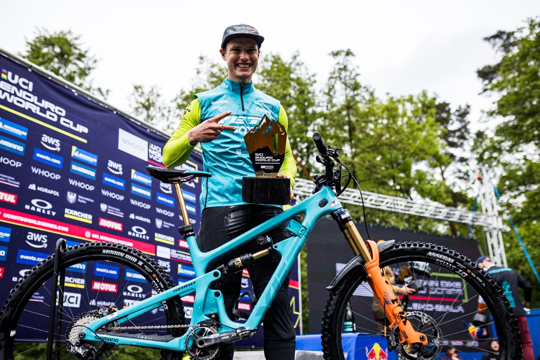 Lukasick posing with his trophy and bike