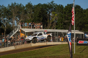 off-road racing truck jumps through the air