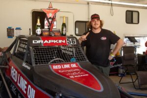 Zac Drapkin In the pit holding up a 1.