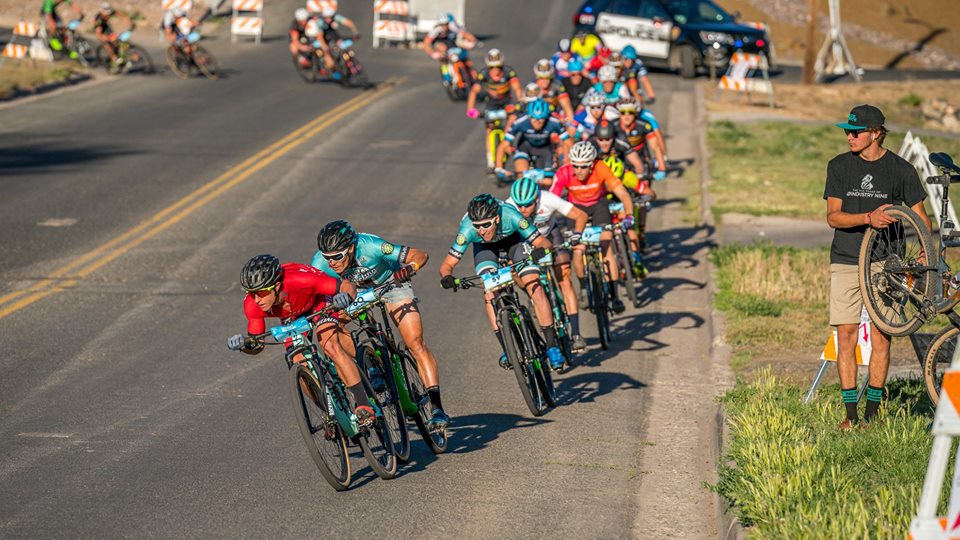 The pro men getting a little aero at the front of the pack.