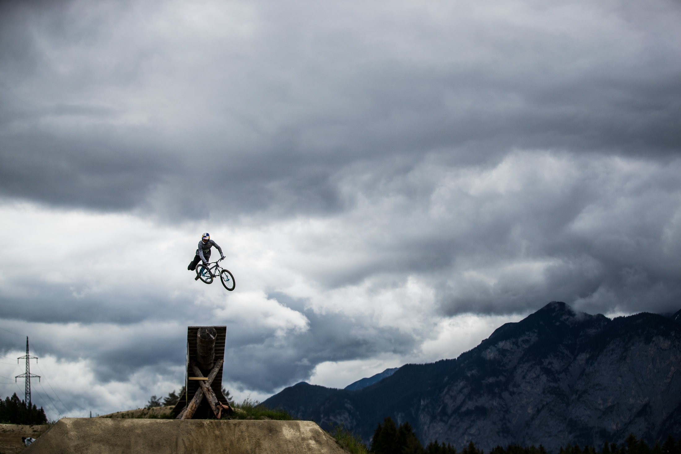 David Godziek tail whips under an ominous sky. Crankworx Innsbruck 2019.