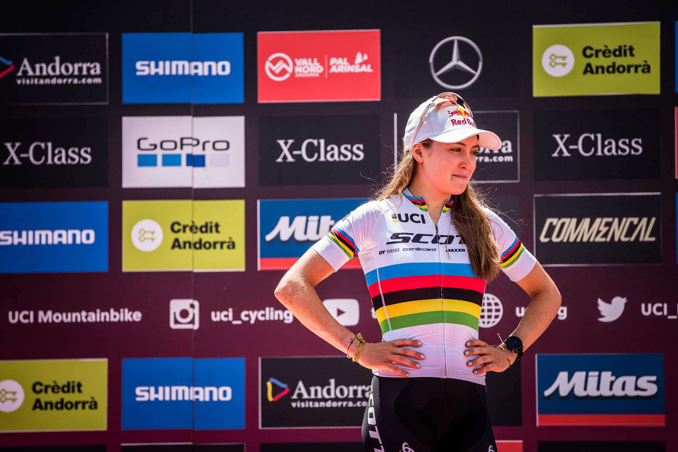 Kate Courtney stands with hands on hips, after a tough day.