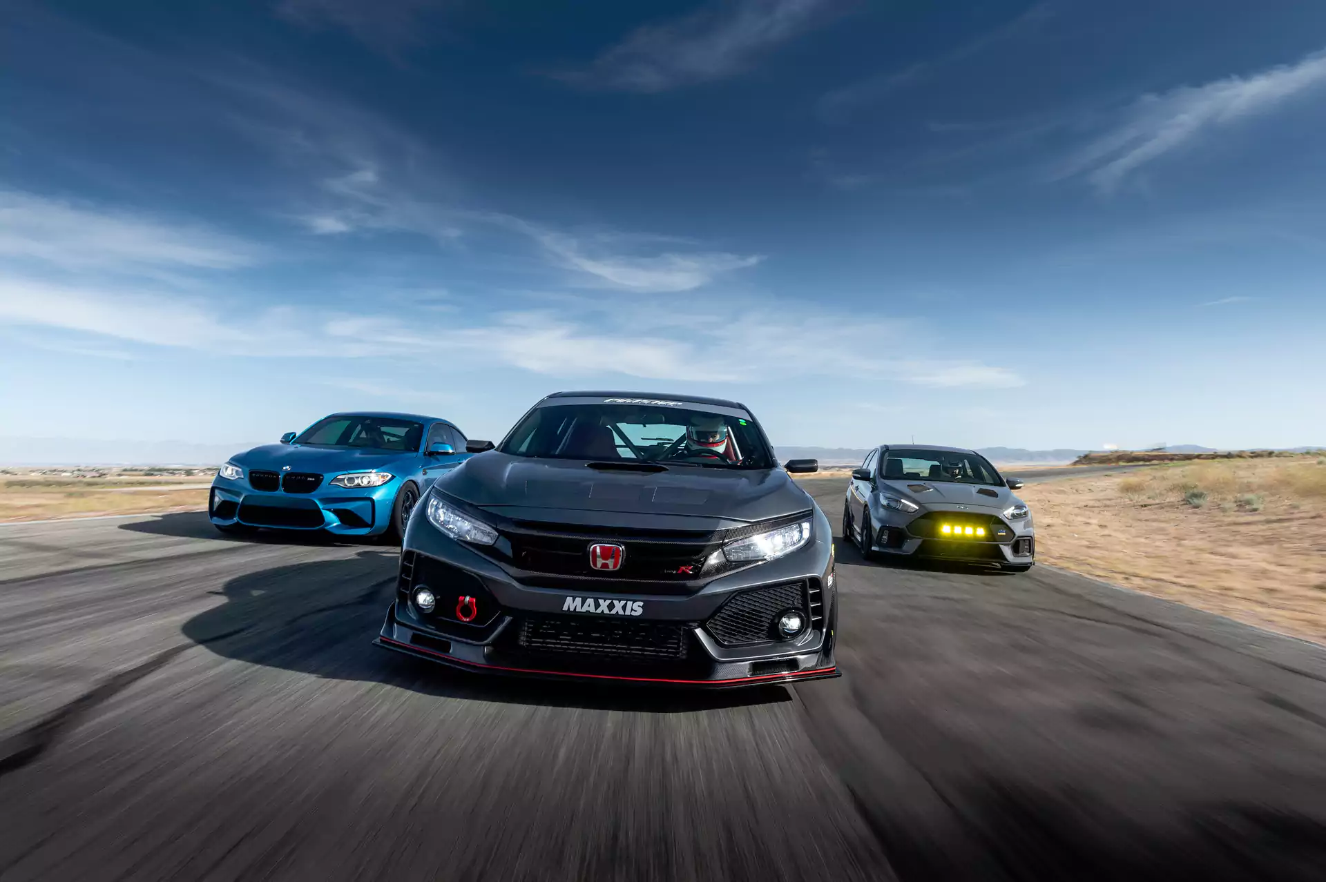 Cars with Maxxis RC1VR1 tires driving on desert road.