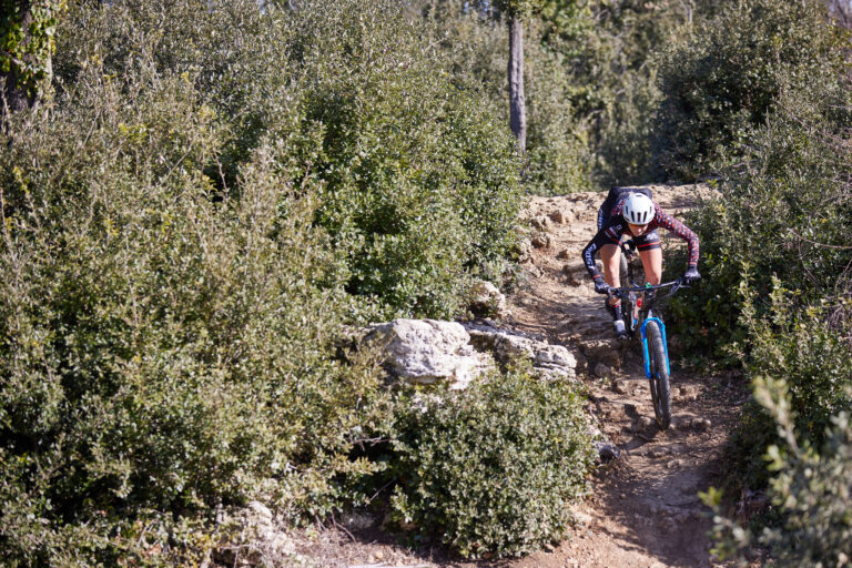 XC rider sending it down rock garden