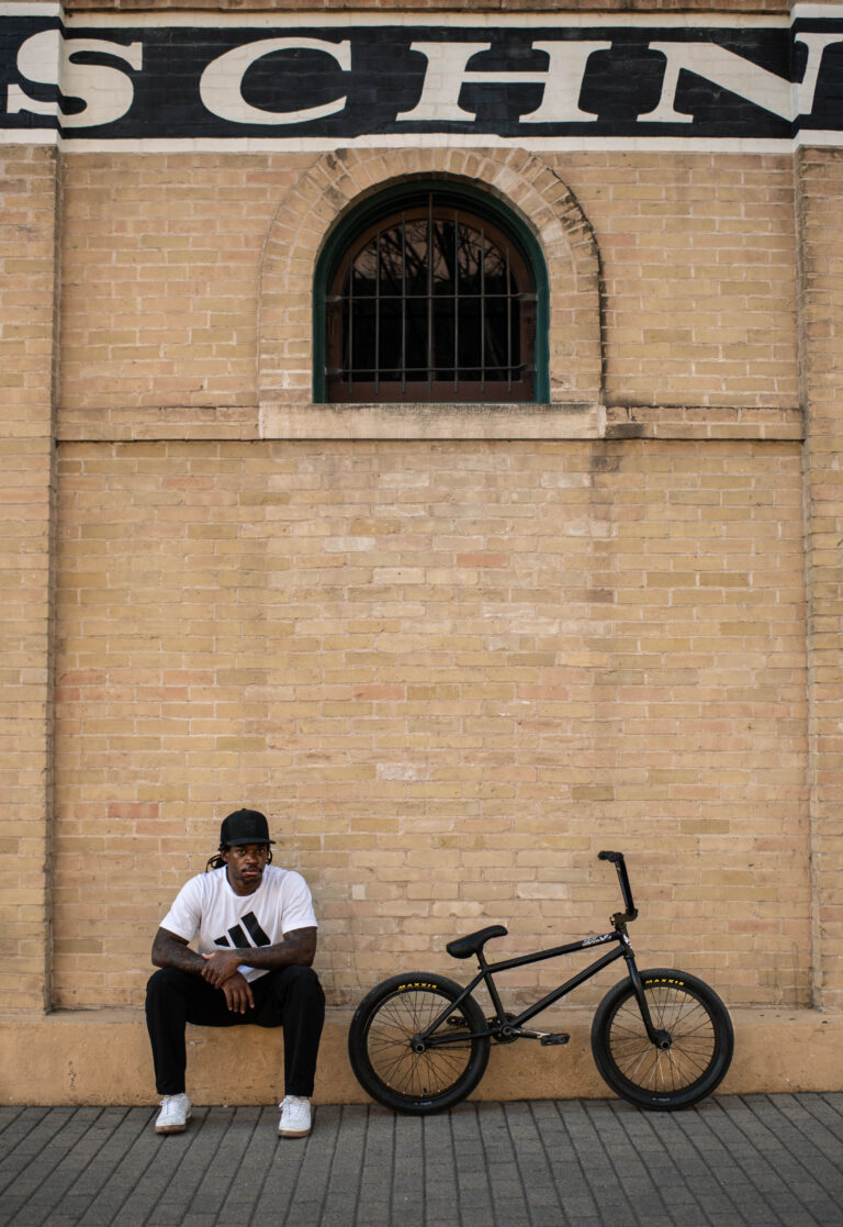 Simms sitting beside his BMX bike