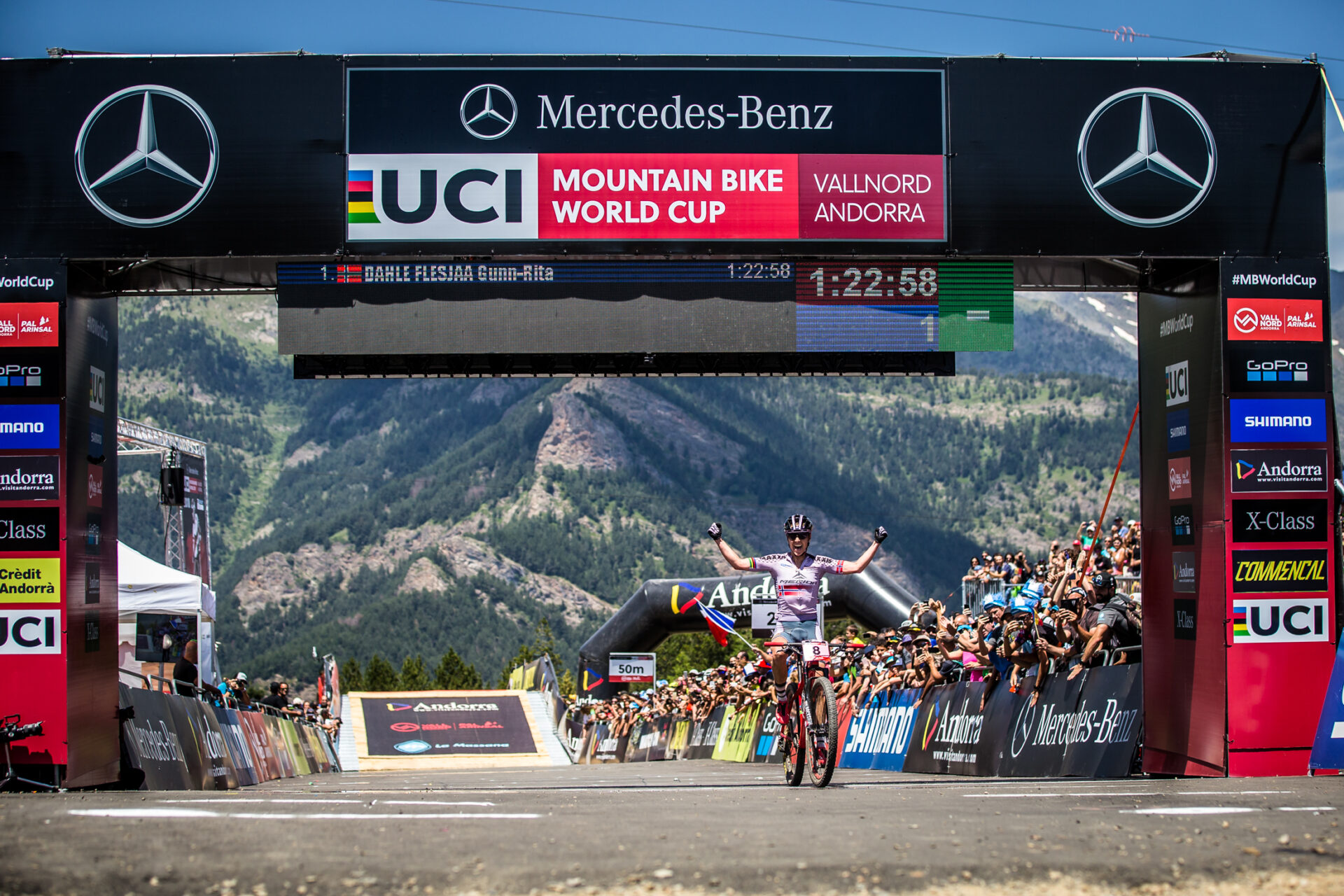 XC racer celebrating at the finish line