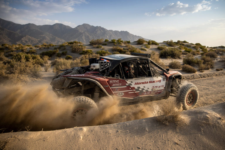 A Honda Offroad Racing Talon SxS powering through a turn.