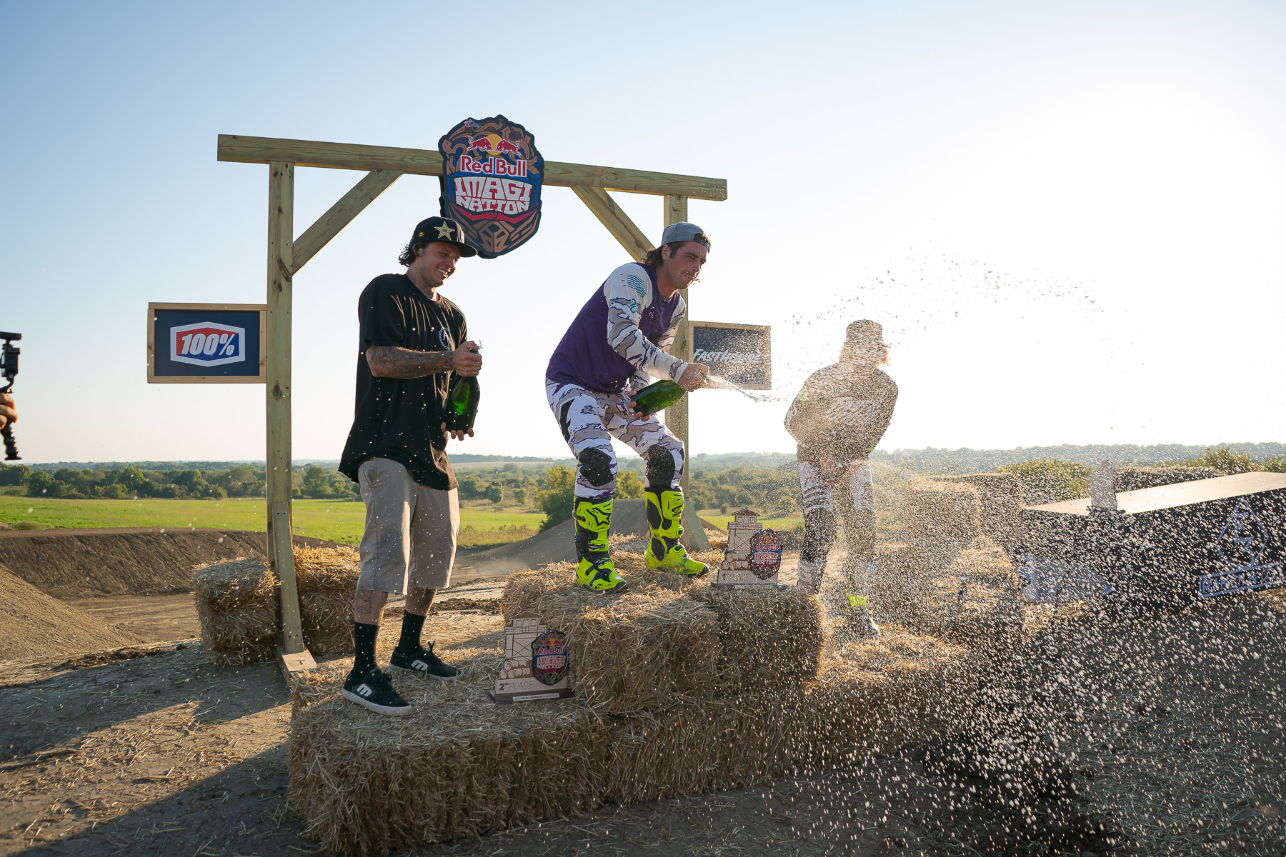 Axell Hodges on the top step of the podium spraying champagne.