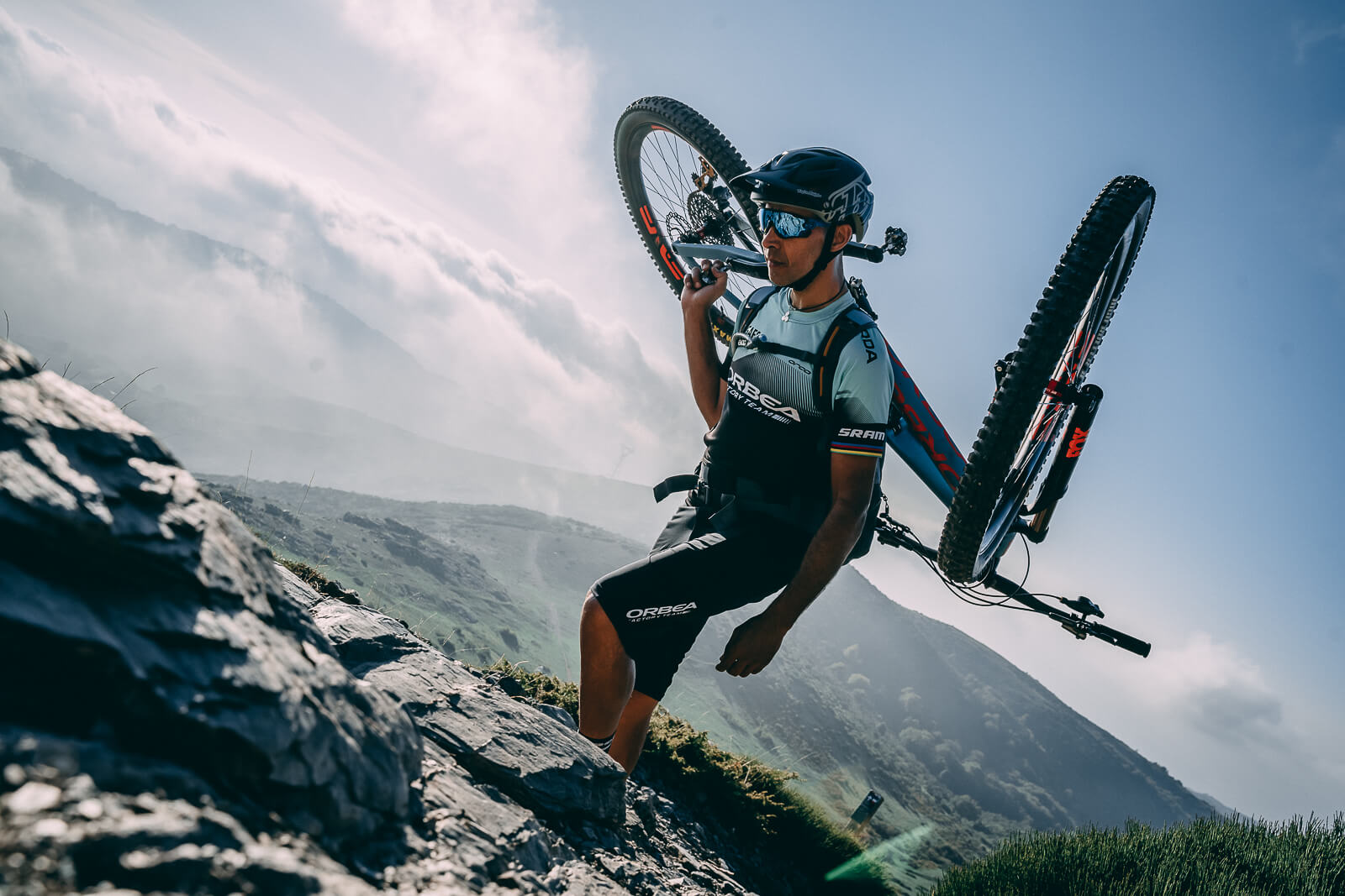 Orbea team rider climbing with his bike