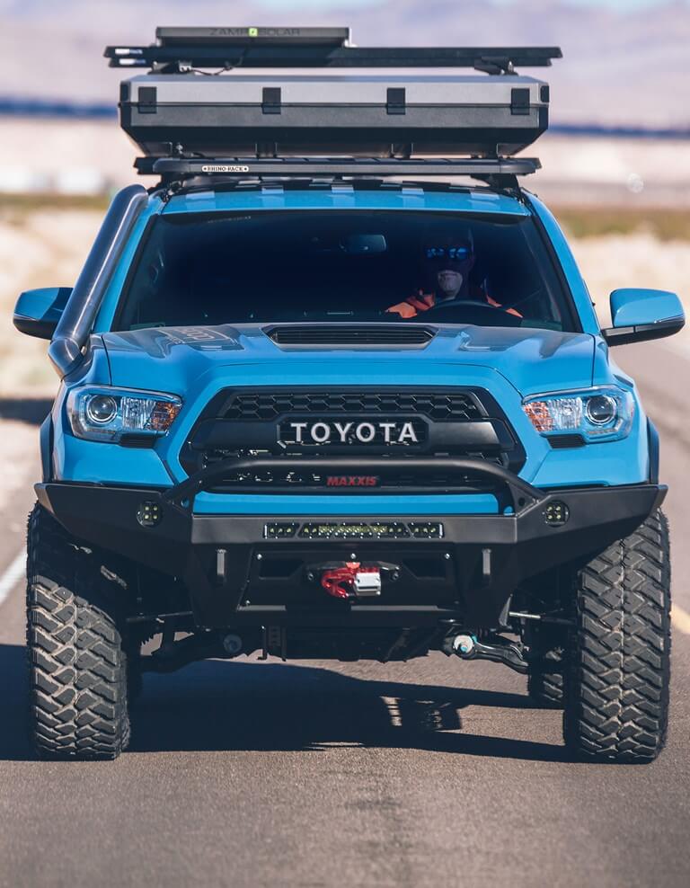 Toyota Tacoma driving on Maxxis RAZR MT tires.