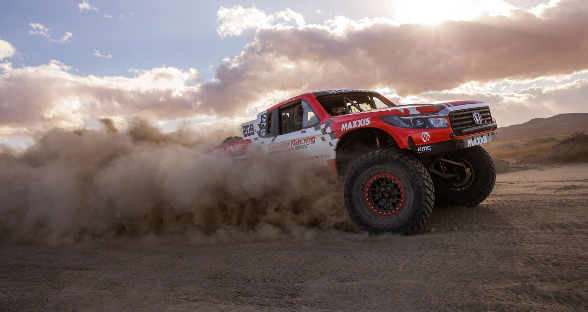 Jeff Proctor race team kicking up dust in a desert race.