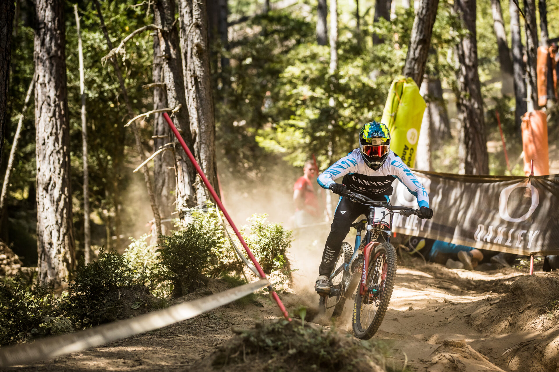 DH rider racing a sandy section