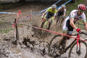 Racers going through a muddy CX course