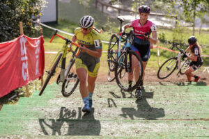 CX racers carrying their bikes up stairs