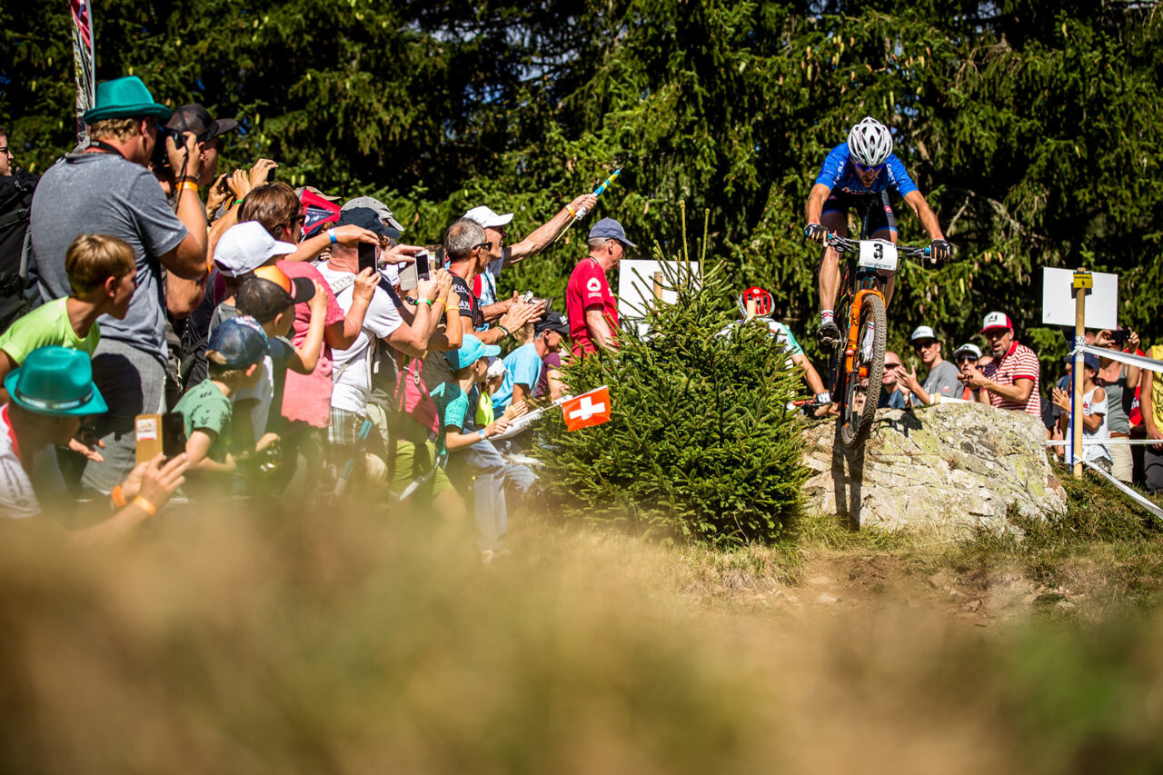 XC racer sending it off a rock