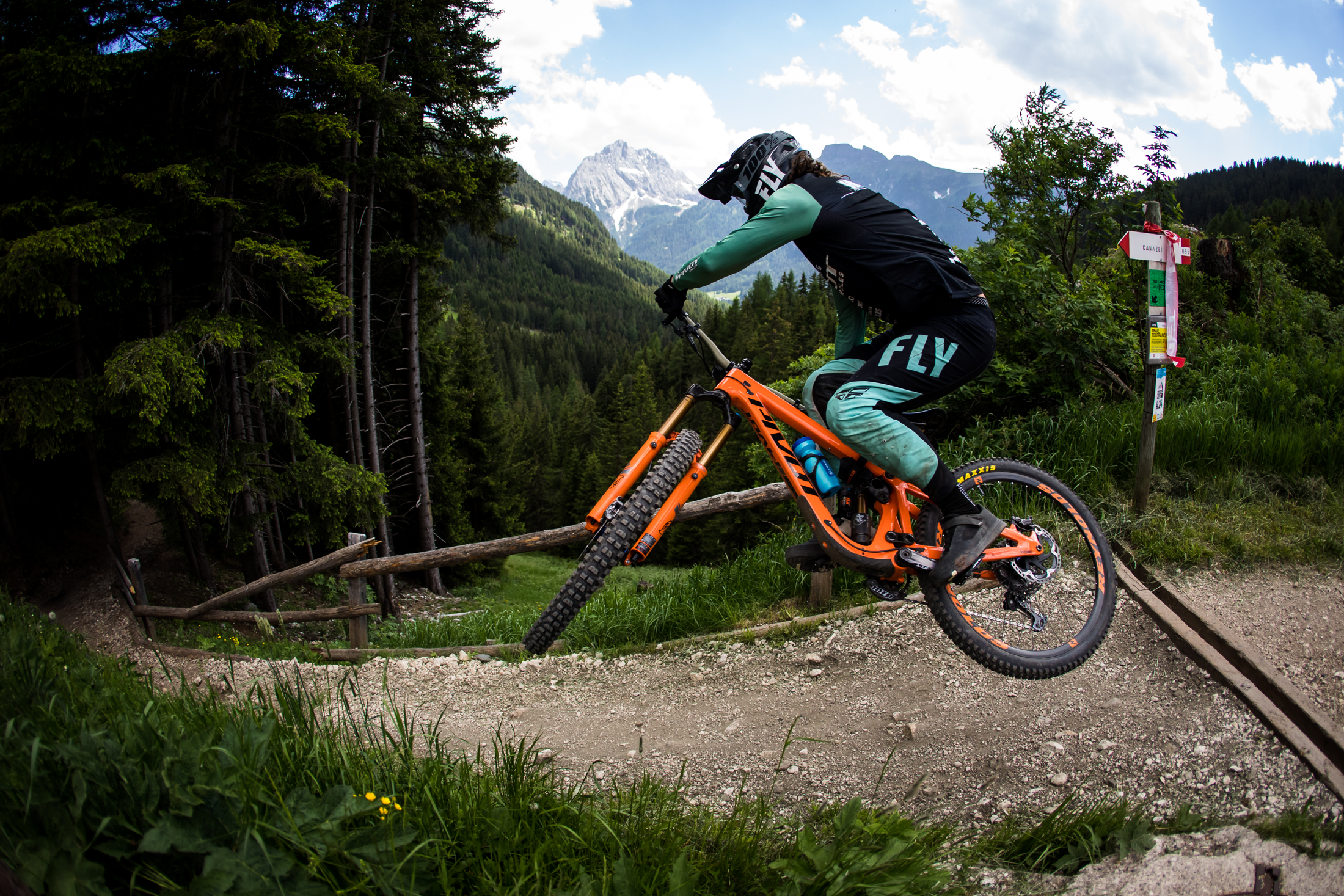 A whip tossed by a Pivot Factory Racer in front of the mountain views