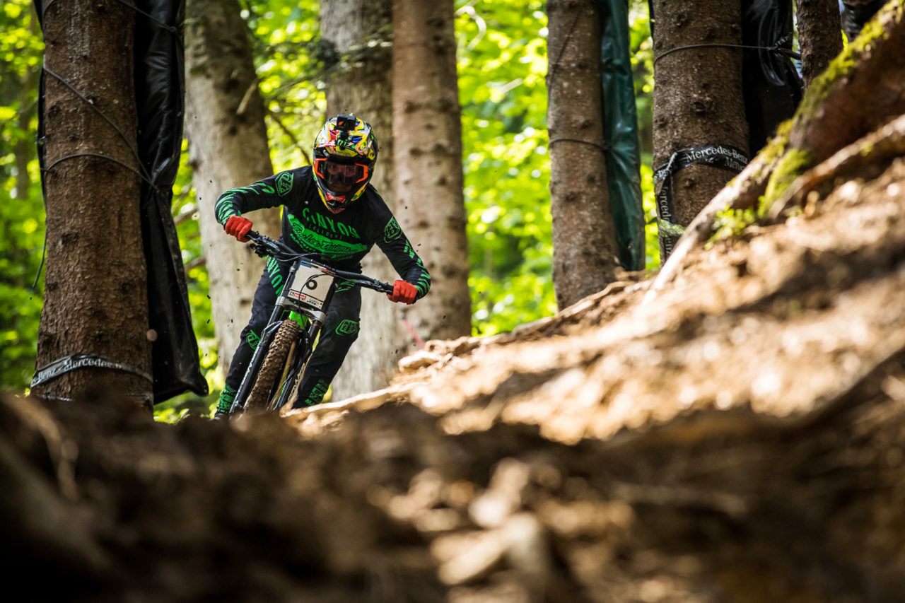 Canyon rider sending it through the forest