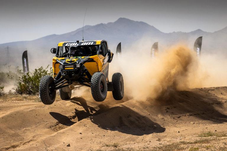 Dustin Jones launching his CanAm SxS off of a sand bank.