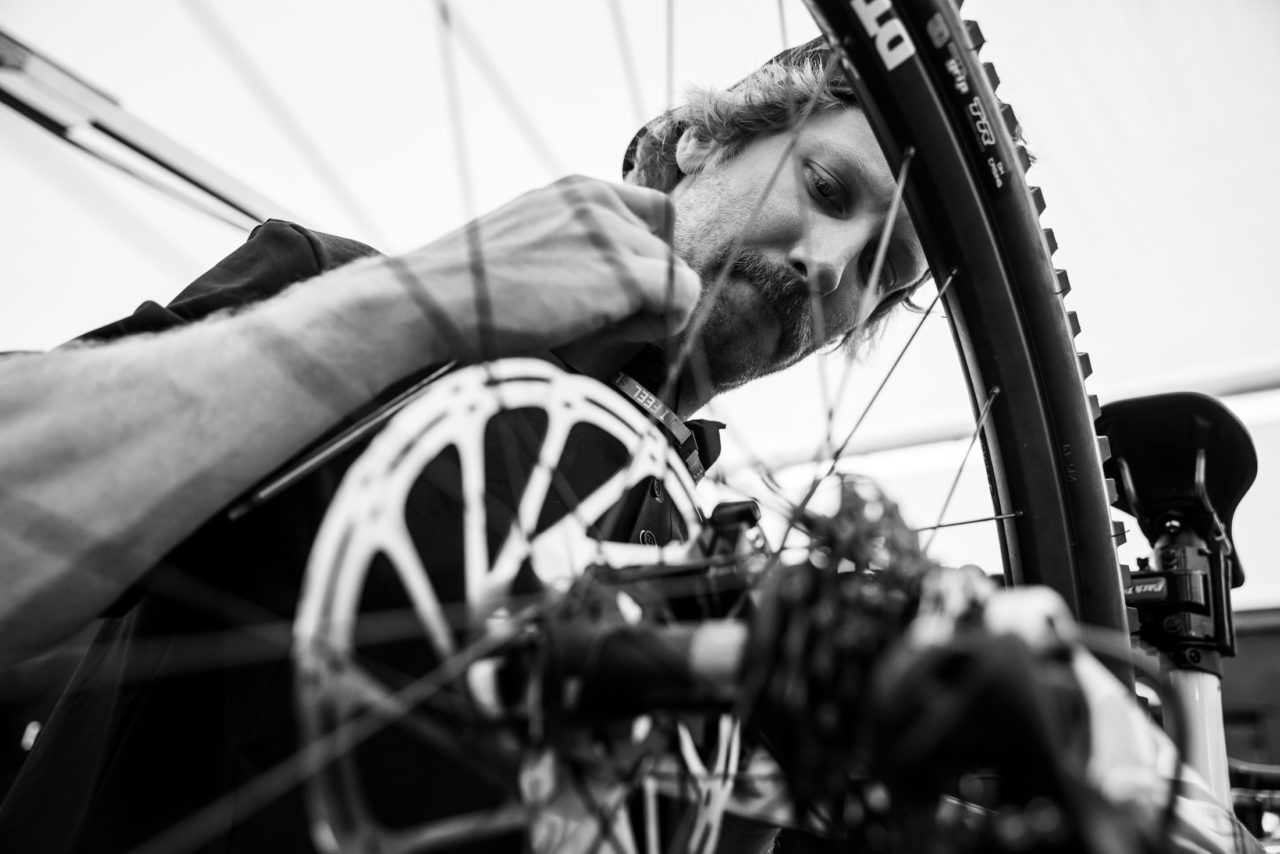 A mechanic looking over a bicycle