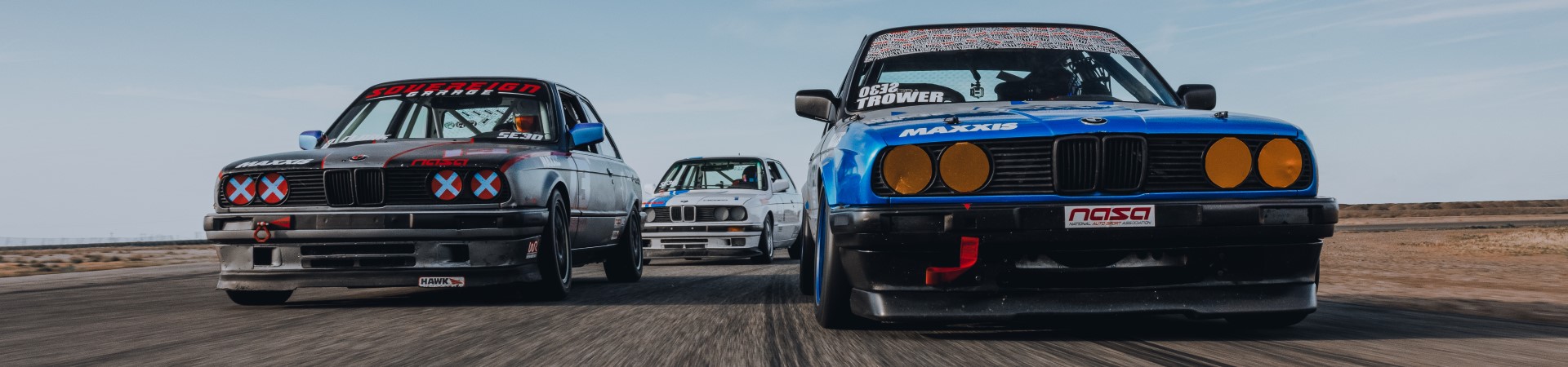 Three BMWs on a race track