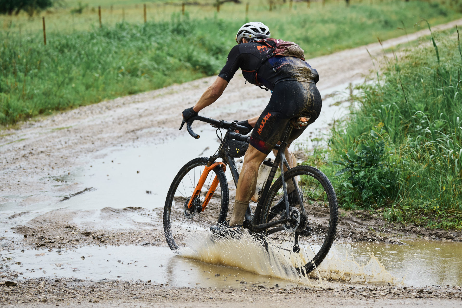 Lespy going through a large puddle on the Unbound course