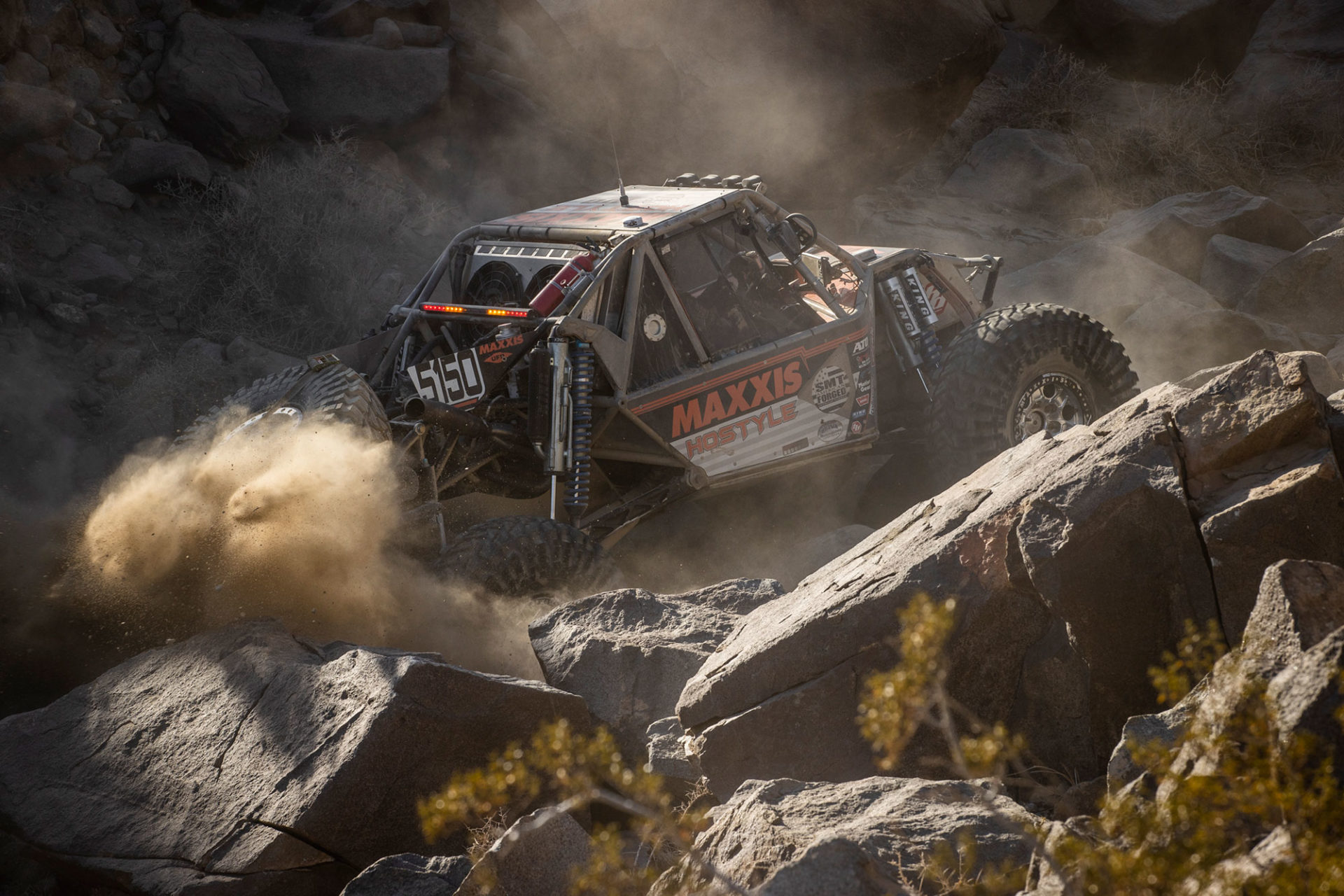 Rock crawling truck climbing rocks.