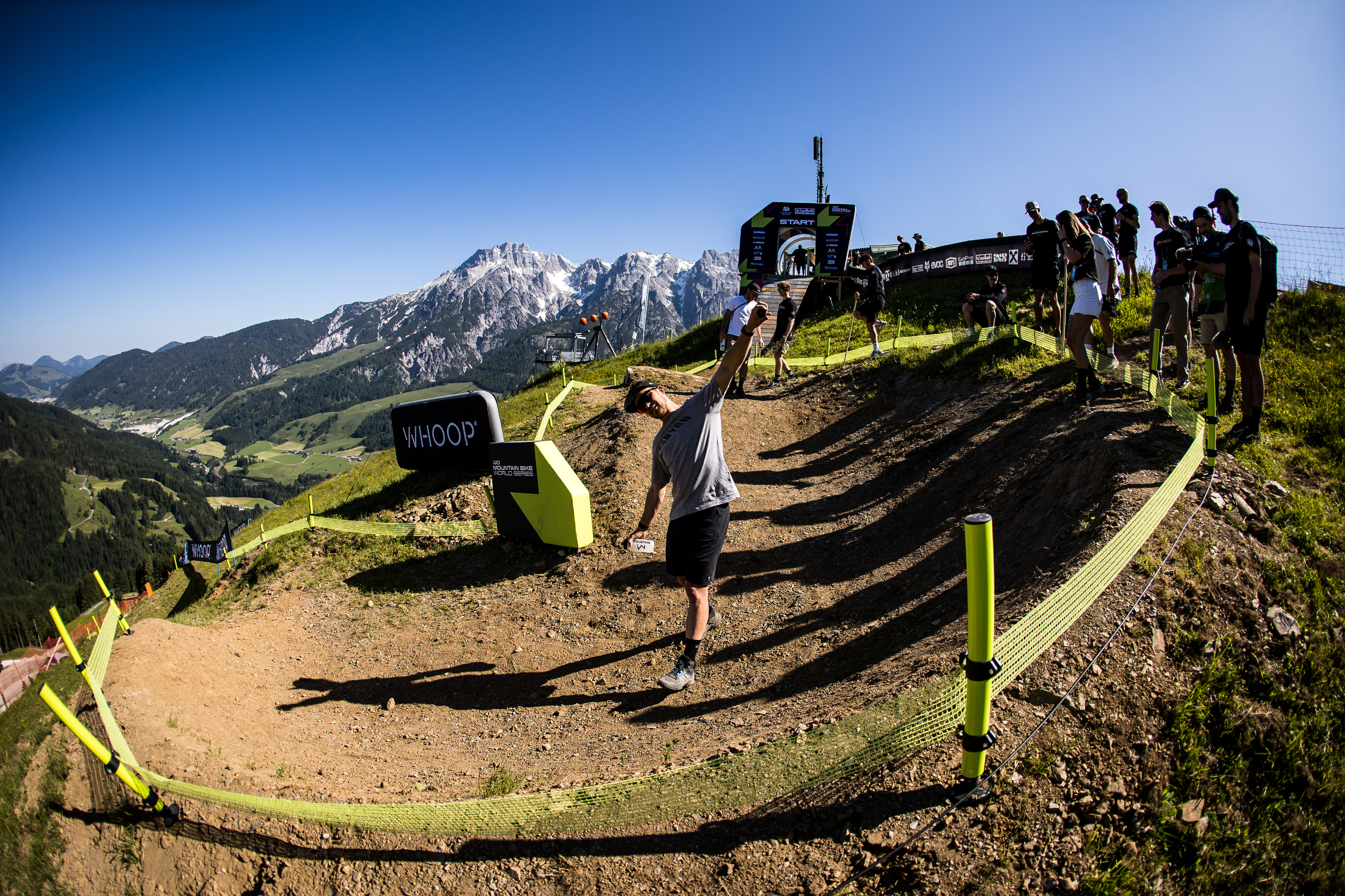 Athlete making an airplane with his arms with Leogang in the background