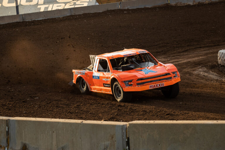 Race truck kicking up dirt