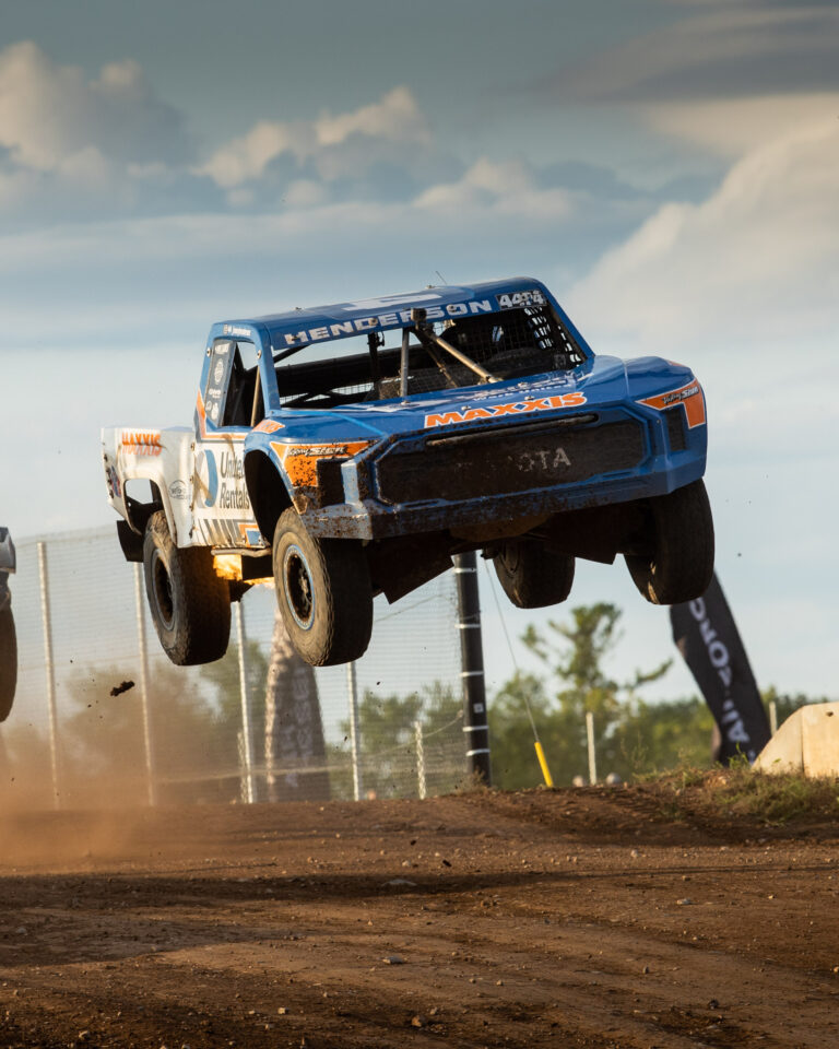 Jimmy Henderson's truck getting air at round 7 of CHAMP racing Dirt City