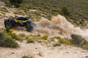 Maxxis rider Dustin “Battle Axe” Jones racing off-road in his CAN-AM UTV vehicle outfitted with Maxxis RAZR XT tires racing action shot