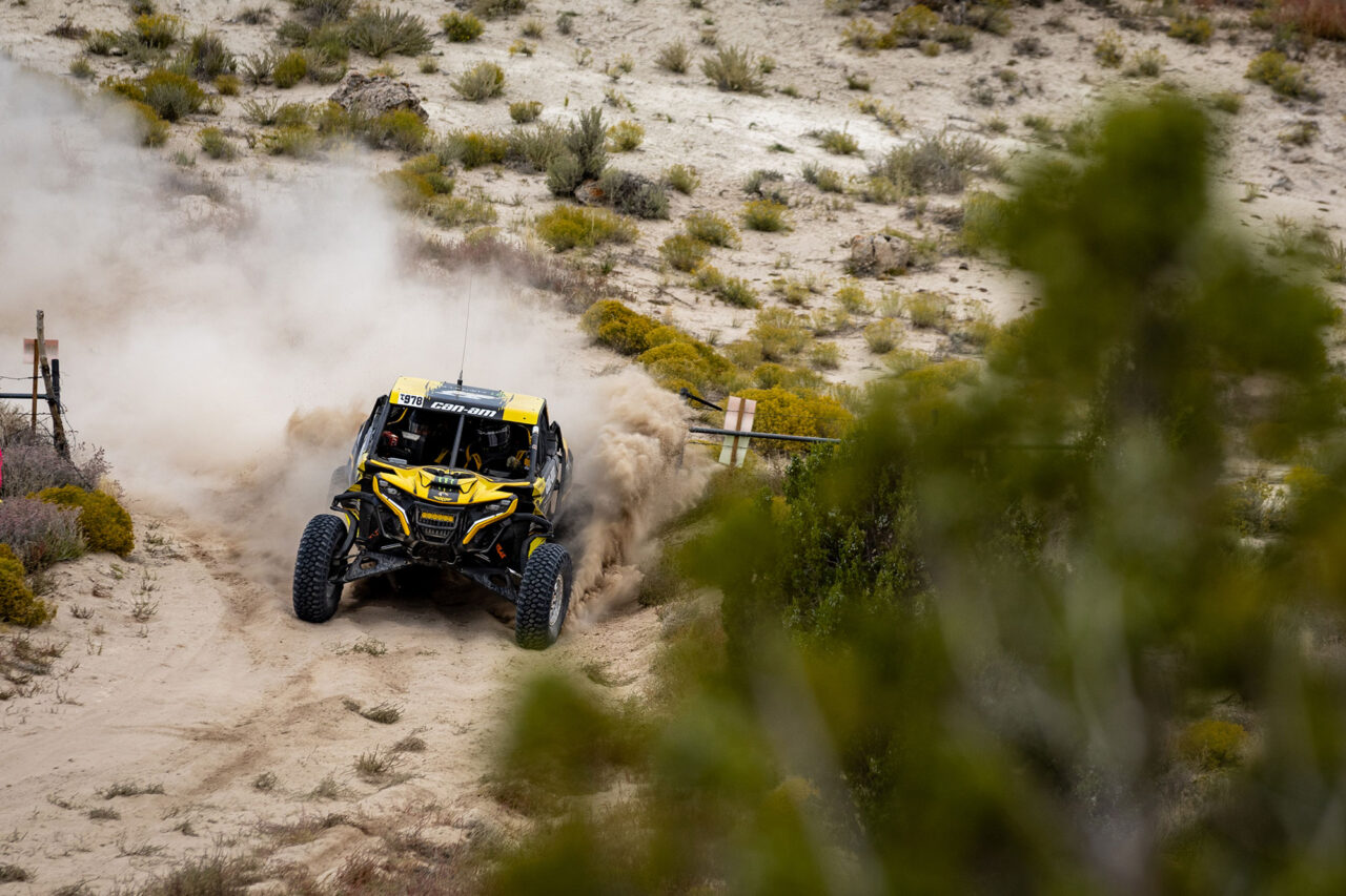 Maxxis rider Dustin “Battle Axe” Jones racing off-road in his CAN-AM UTV vehicle outfitted with Maxxis RAZR XT tires racing action shot