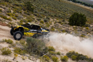 Maxxis rider Dustin “Battle Axe” Jones racing off-road in his CAN-AM UTV vehicle outfitted with Maxxis RAZR XT tires racing action shot