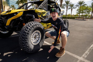 Dustin “Battle Axe” Jones with his Can-Am UTV showing off a set of MAXXIS RAZR XT tires