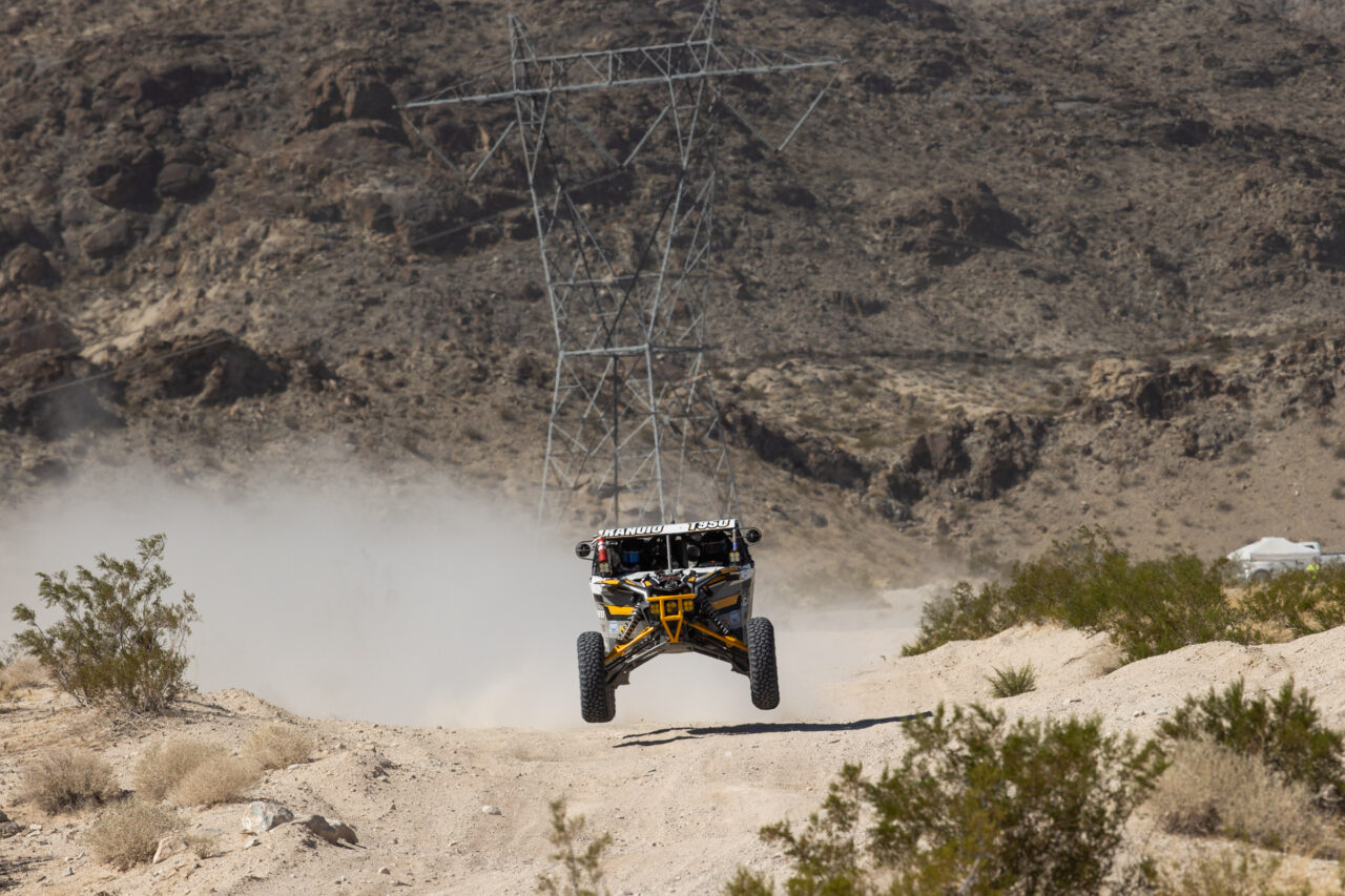 Maxxis rider Ranuio Jones #1950 racing off-road in his CAN-AM UTV vehicle outfitted with Maxxis RAZR XT tires.