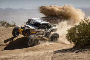 Maxxis rider Ranuio Jones #1950 racing off-road in his CAN-AM UTV vehicle outfitted with Maxxis RAZR XT tires.