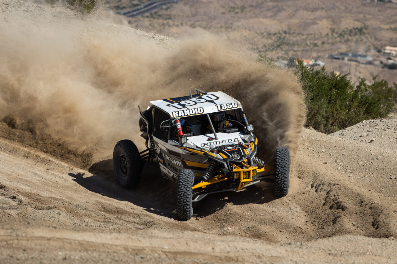 Maxxis rider Ranuio Jones #1950 racing off-road in his CAN-AM UTV vehicle outfitted with Maxxis RAZR XT tires.