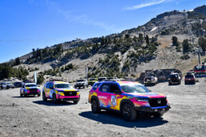 3 vehicle group image of Team #208, Team #211 and Team #212 outfitted with Maxxis’ flagship all-terrain Maxxis RAZR AT tires on dirt road in off-road terrain with mountains in the background.