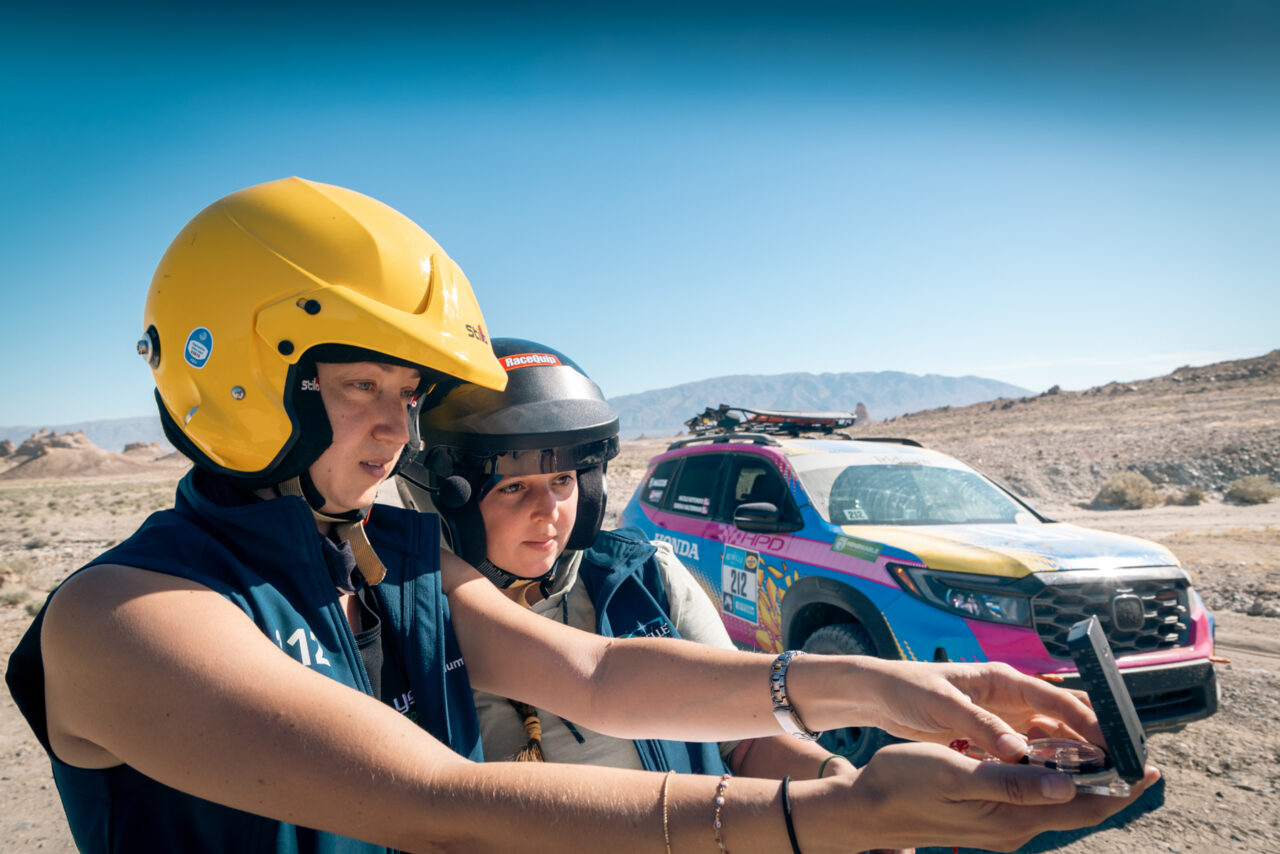 Team #212 Nicole Rotondo and Serena Halterman of Honda Performance Development (HPD) with their Honda Passport Trail Sport using an analog navigation compass.