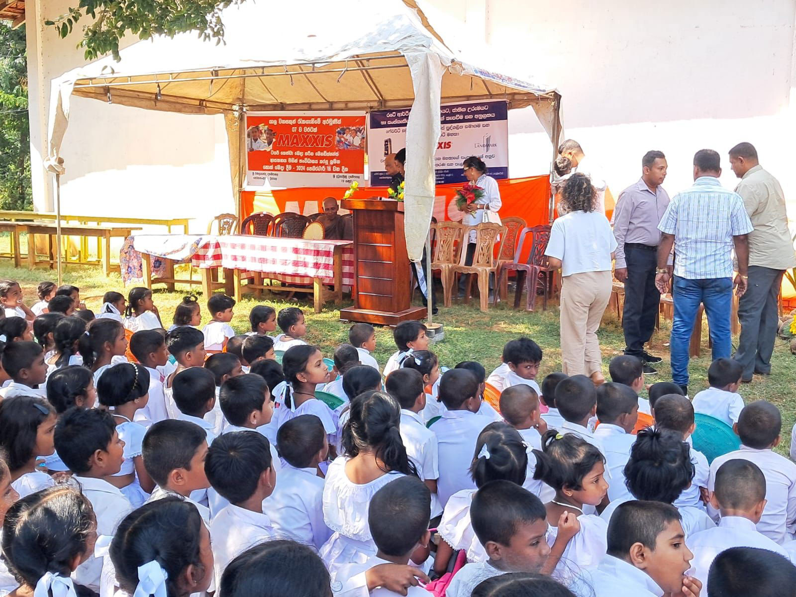 Group of school children sitting patiently.