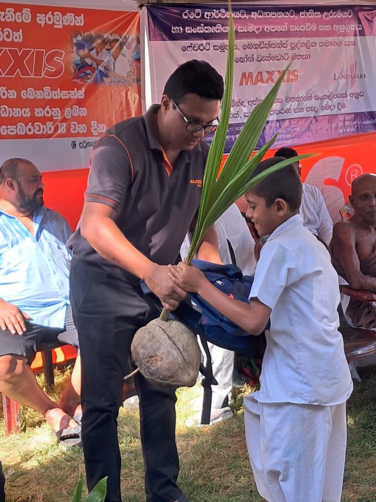Man giving a child a back packs and coconut tree.