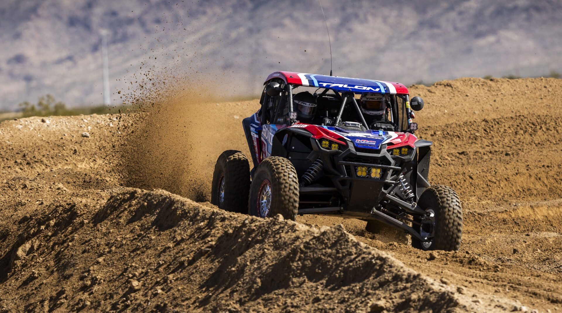 Honda SxS racing through dirt