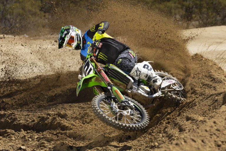 Jeremy taking a dirt curve making a rooster